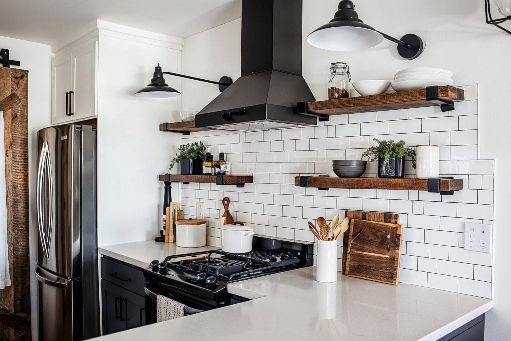 Open shelving and industrial elements in a kitchen by Decorilla