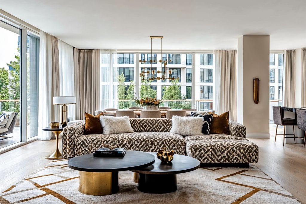 Boldly accentuated conversation area in an open plan monochrome living room by Decorilla