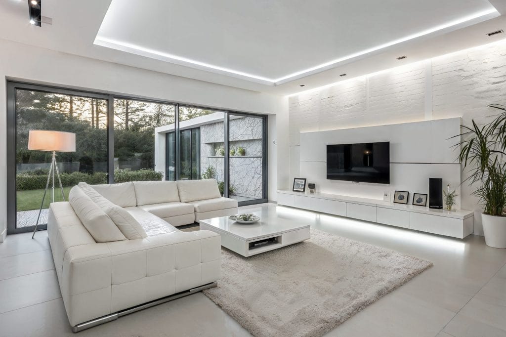 Minimalist all-white interior of a monochromatic living room by Decorilla