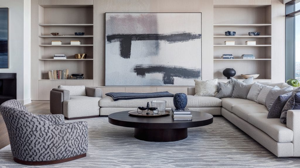 Oversized abstract art in a monochromatic living room by Decorilla