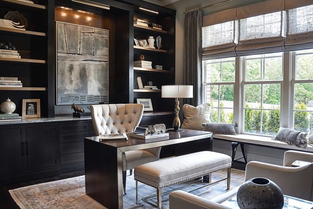 Modern built-in library home office design by Decorilla featuring tufted furniture