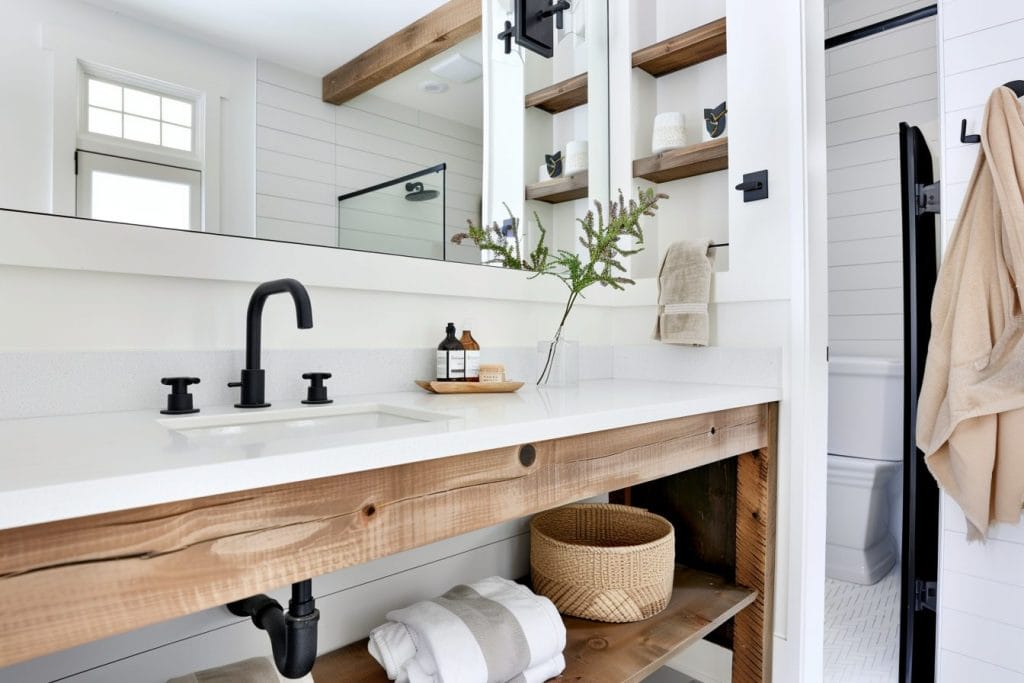 Modern farmhouse decor with rustic and industrial elements in a bathroom by Decorilla