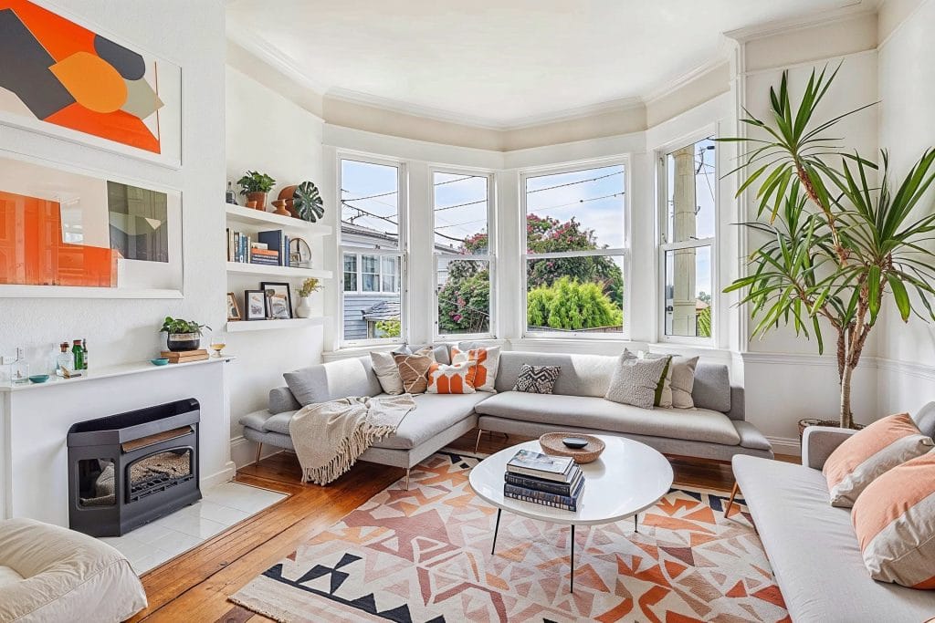 Bright small living room with a fireplace by Decorilla