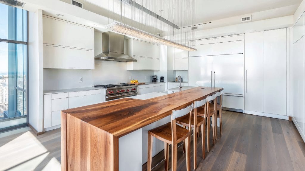 Butcher block waterfall countertop in a kitchen by Decorilla