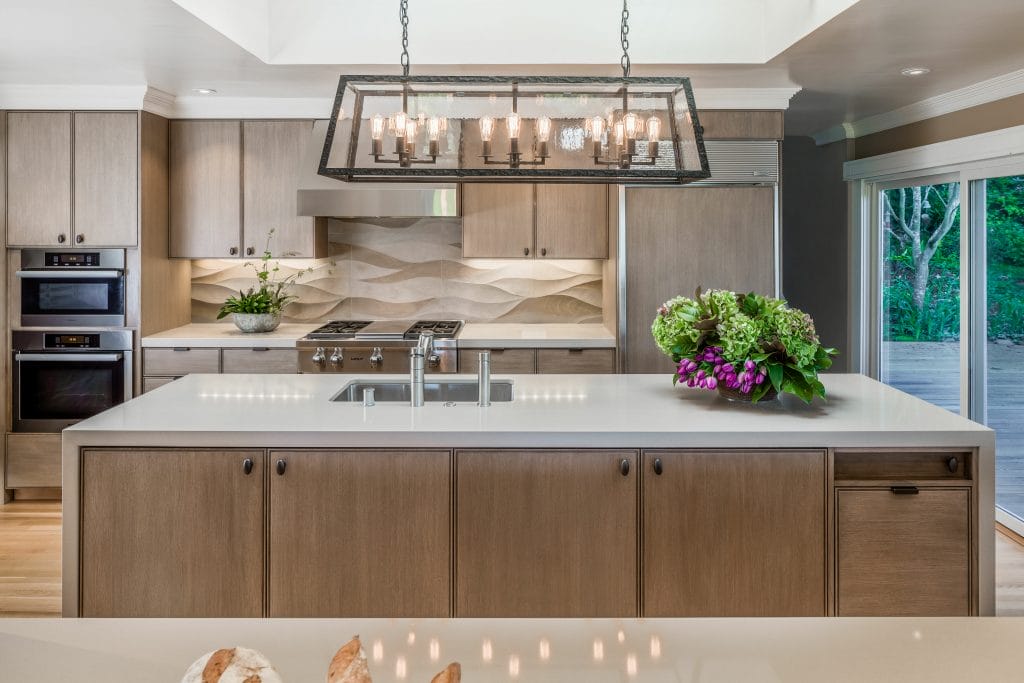 Granite waterfall countertops in a kitchen by Decorilla