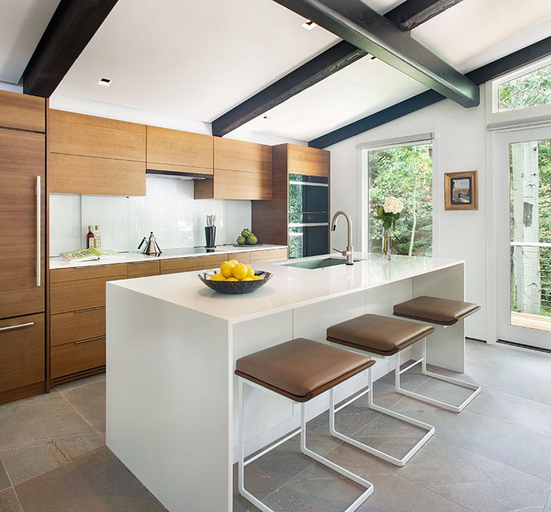 Practical small kitchen island with stackable chairs by Decorilla