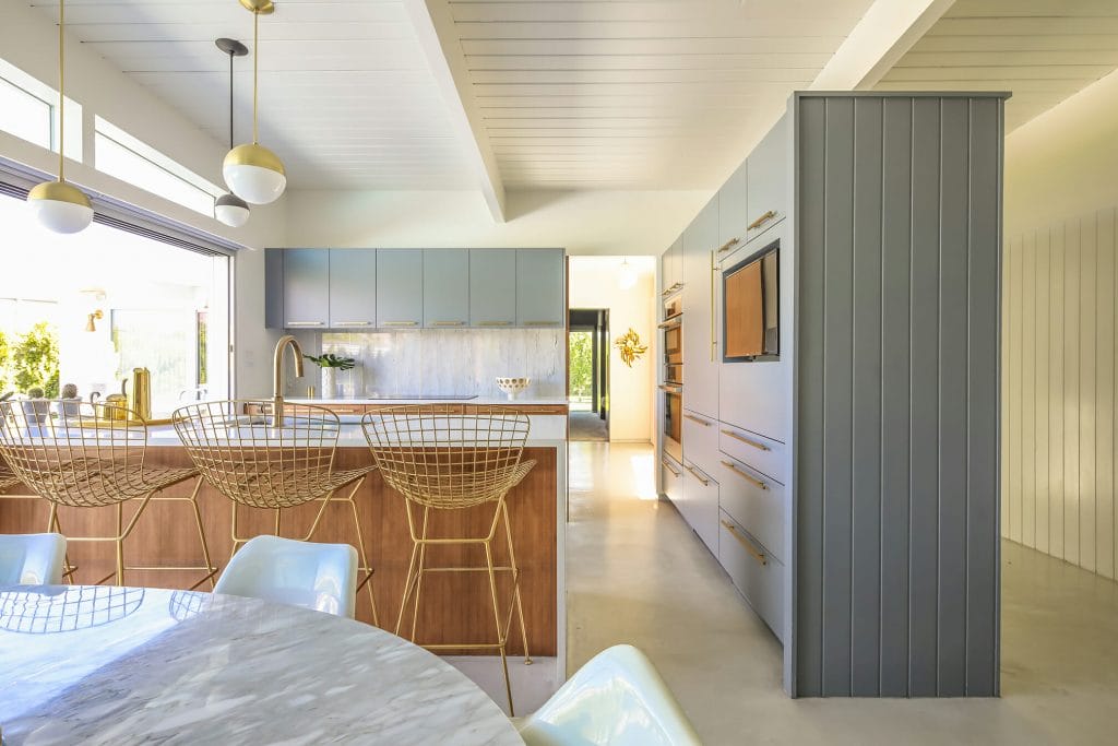 Small kitchen remodel with statement lighting and updated countertops by Decorilla