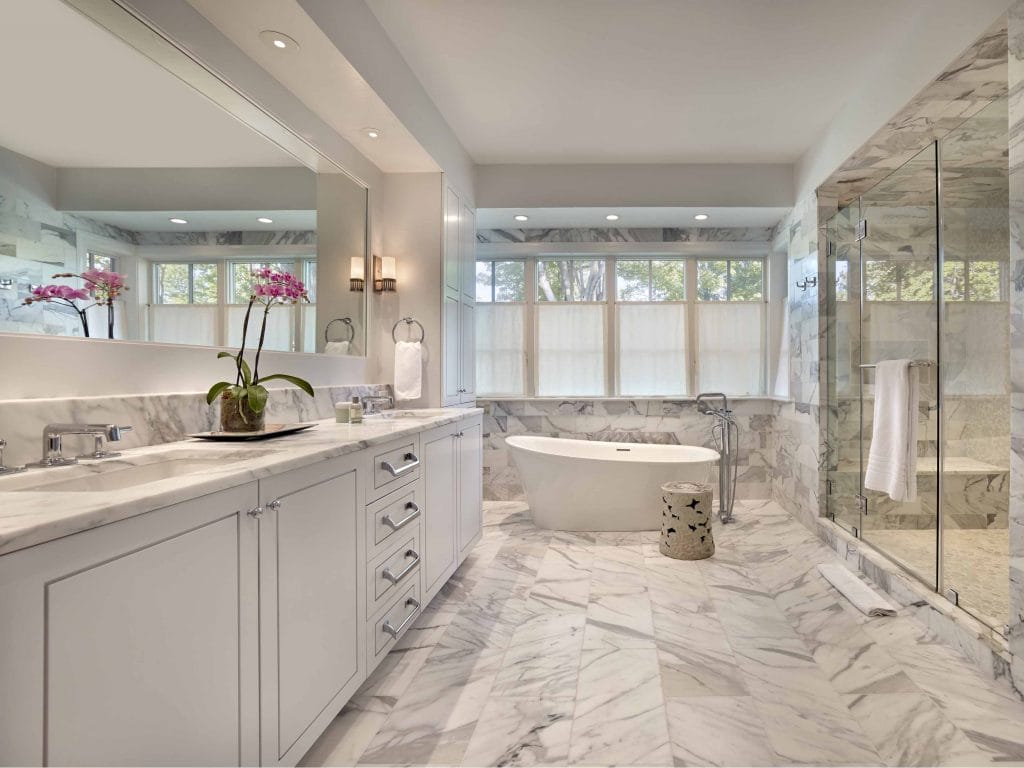 A smart bath surrounded by natural textures and soft lighting in a bathroom by Decorilla designer Rachel H.