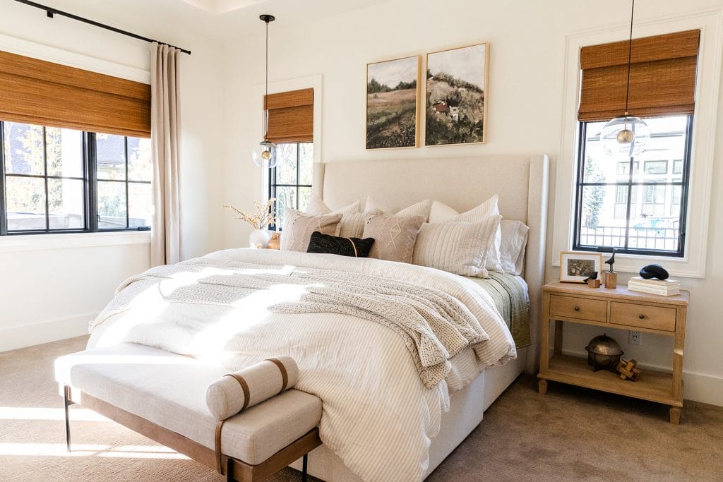 Neutral bedroom ideas with layered off-whites in an interior by Decorilla designer, Sharene M.