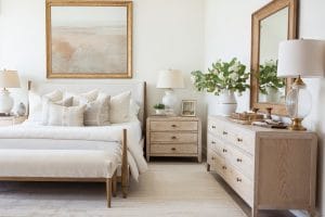 Neutral bedroom ideas with layered textures and patterns by Decorilla