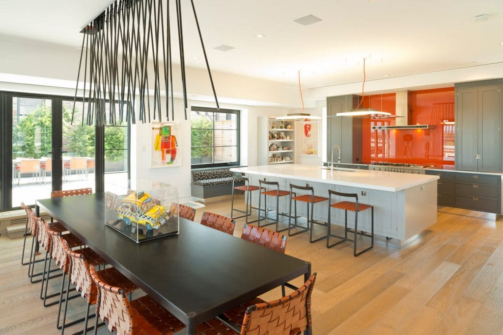 Two-tone grey kitchen cabinets in a bold open layout by Decorilla