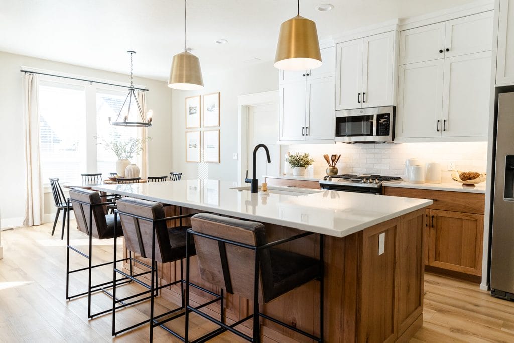 Two-tone wood kitchen cabinets combining white and wood finishes, by Decorilla