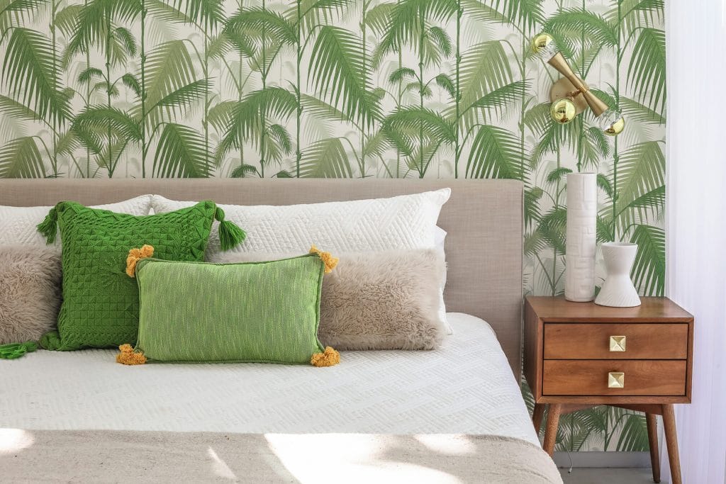 Bright green accent wall and details in an MCM bedroom by Decorilla designer, Michelle B. 