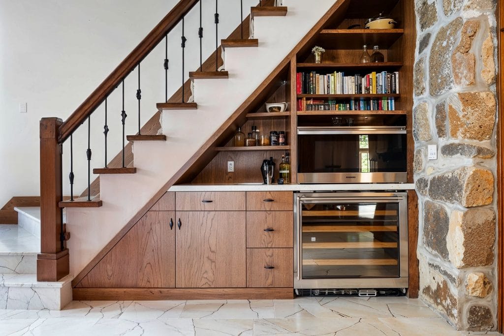 Understairs storage hacks keep organized in this home by Decorilla